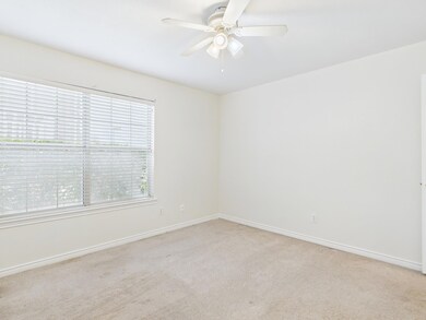Spare room with baseboards, a ceiling fan, and lig