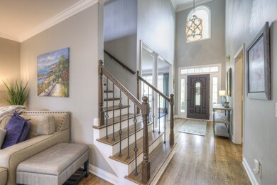 Large foyer with high ceilings and large windows for a warm, welcoming entryway