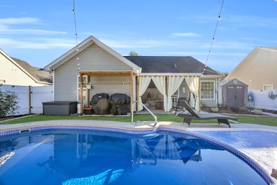 Rear view of house featuring a storage shed