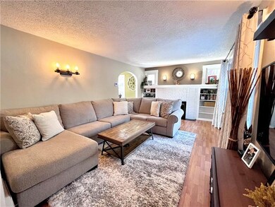 Spacious living room with decorative fireplace and
