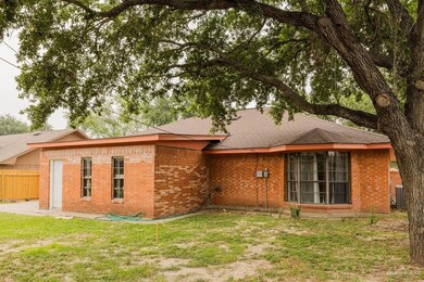 View of front of home with brick siding, cooling unit, and a shingled roof
