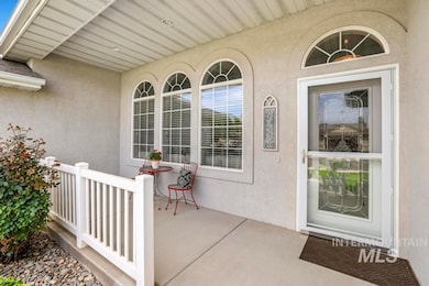 Doorway to property featuring stucco siding and covered porch
