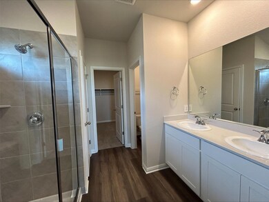 Bathroom with wood finished floors, a stall showe