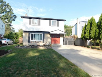 Colonial home featuring brick siding and a chimney