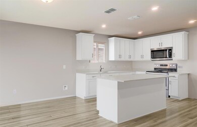 White cabinetry and LVP flooring *Photos of furnis