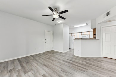 Unfurnished living room with a ceiling fan, light