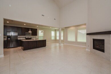 Effortless flow between the grand family room and kitchen makes everyday living and entertaining a breeze