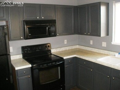 Kitchen with sink and black appliances