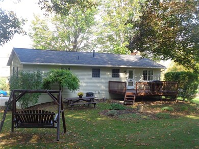 Rear deck overlooking  large treed lot