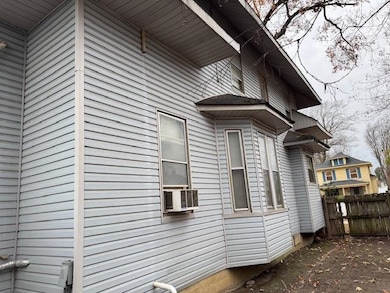 View of side of property featuring cooling unit