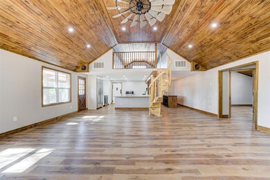 Unfurnished living room with wood ceiling, high va