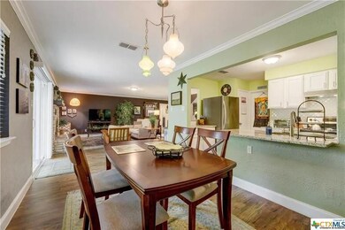 Dining room featuring crown molding and wood finished floors