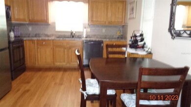 Eat-in kitchen with wood cabinets, LG appliances, smooth top stove with microwave over stove, dishwasher.