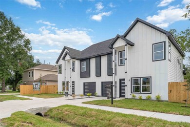 This modern two-story home features a sleek exterior with contrasting black and white paneling. It includes large windows for natural light, a double garage, and a neatly landscaped front yard. Situated in a suburban neighborhood, it offers a spacious driveway and a fenced backyard for privacy.