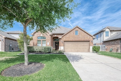 The shade provided by the towering trees in the front yard offers a refreshing respite from the sun, creating a cool and inviting ambiance. Adjacent to the lush greenery, the expansive double-wide driveway adds both functionality and aesthetic appeal, providing ample space for parking and enhancing the overall grandeur of the property.