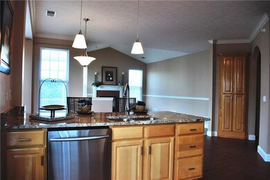 The freshly painted kitchen has crown moulding wit