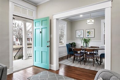 Entrance foyer featuring crown molding and hardwood / wood-style floors