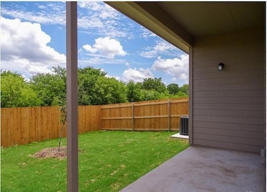 Fenced backyard with a patio