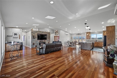 Living room featuring vaulted ceiling with skyligh