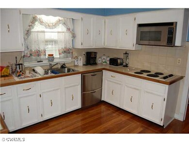 Kitchen - Kitchen: eat-in with hardwood floor, tiled countertops, double wall ovens, electric cook top, double drawer stainless steel dishwasher, work station area, white cabinets with crown molding and chair rail and pantry