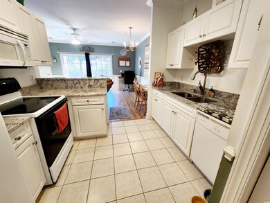 Kitchen featuring sink, white cabinetry, ornamenta