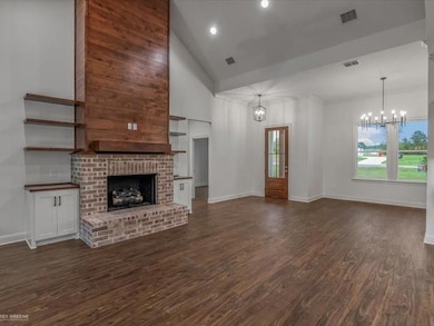 Unfurnished living room featuring a brick fireplac