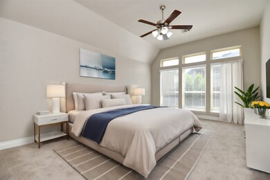 The serene primary bedroom suite features a vaulted ceiling and large windows, creating a peaceful retreat. Enjoy the spacious layout, plush carpeting, and elegant decor that make this room a true sanctuary.
