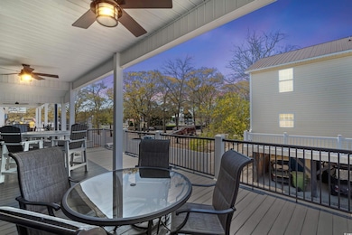 Wooden deck with outdoor dining area and ceiling f