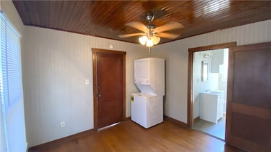 Laundry area with stacked washer / dryer, wood fin