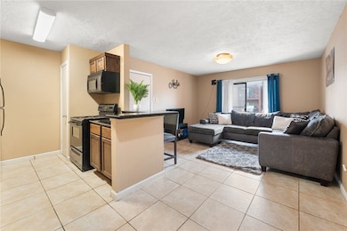 Kitchen with open floor plan, black appliances, da