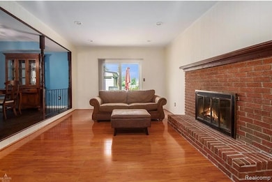 Family room with a fireplace, light wood finished floors, and recessed lighting