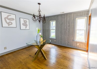 Spare room featuring hardwood flooring, natural li