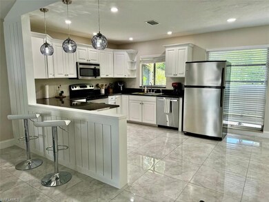 Immaculate cabinetry, granite countertops, stainless steel appliances, and abundant storage make this kitchen ideal for both function and style.