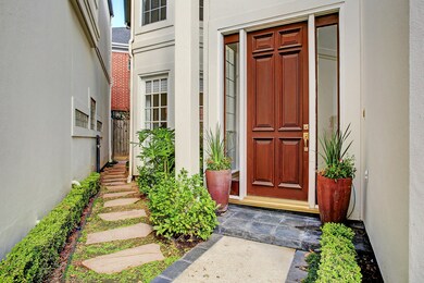 Attractive front door away with walkway to private patio area.