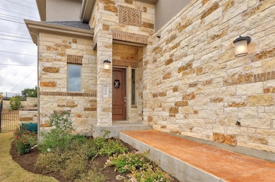 View of exterior entry with stone siding