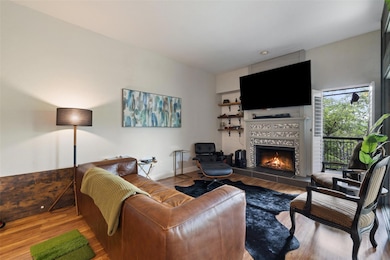 Living room featuring a tiled fireplace, wood fin