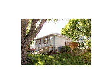 Raised Ranch With Wrap around Deck & Mature Trees.