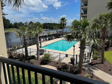 View of swimming pool with a patio and a water vie