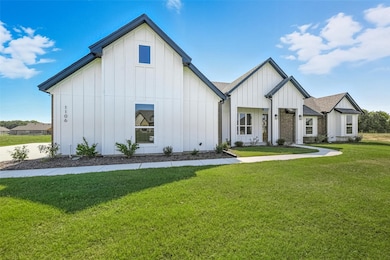 Modern farmhouse with board and batten siding and a front yard