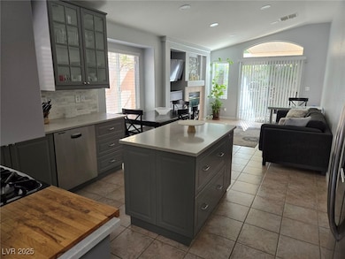 Kitchen featuring gray cabinetry, open floor plan,