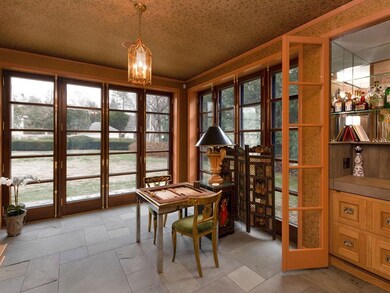 Bright sun room with bluestone floor, custom de Giulio wet bar, custom French doors to back yard