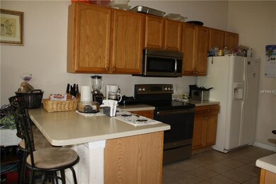Kitchen with wood cabinets and solid surface top