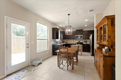 Dining space featuring light tile patterned floor