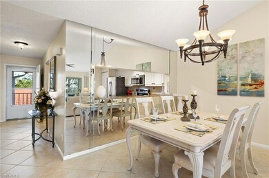 Tiled dining area featuring lofted ceiling, a nota