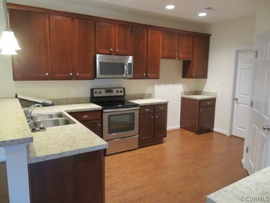 Wide open kitchen with stainless appliances, lamin
