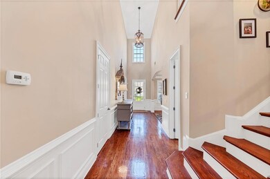 Entrance foyer with stairs, dark wood-type floorin