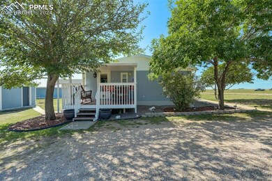 View of front facade with a front yard and a porch