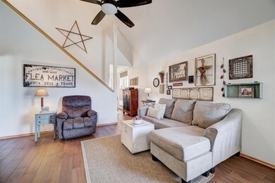 Living area with baseboards, wood look finished ce