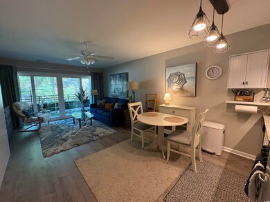 Dining room with wood finished floors, a ceiling fan, and baseboards