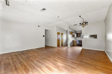 Unfurnished living room featuring a textured ceili